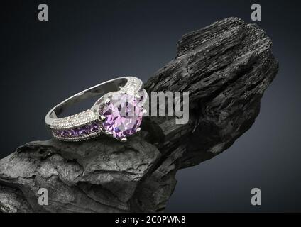 Jewelry ring with tourmaline on black stone, on dark background Stock Photo