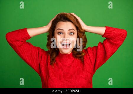 Portrait of astonished positive woman hear wonderful lottery win novelty impressed touch hands redhead scream wear knitted winter sweater isolated Stock Photo