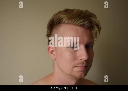 Young Man in His Mid-20s with Shaved Side Hairstyle Smiling at the Camera Stock Photo