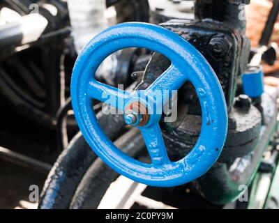 Pipes and valve with blue faucet on a ship Stock Photo