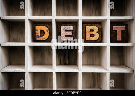 Debt Concept Wooden Letterpress Type in Draw Stock Photo