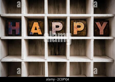 Happy Concept Wooden Letterpress Type in Draw Stock Photo