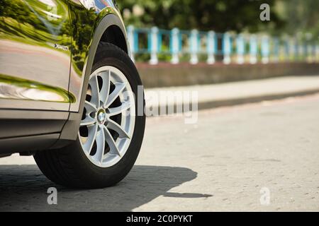 GRODNO, BELARUS - JUNE 2020: BMW X3 II F25 2.0i xDrive wheel alloy wheels with summer tires with BMW logo closeup on background of summer city Stock Photo