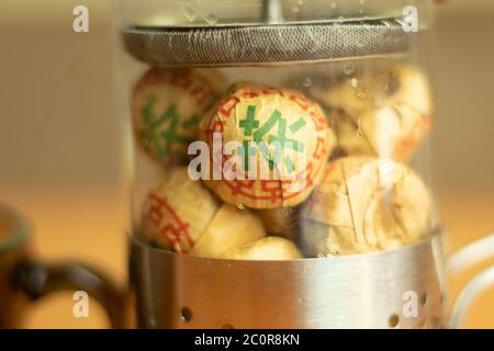 Macro shot of herbal black tea. Traditional chinese puer tea in packs. Stock Photo