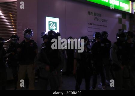 Hong Kong, CHINA. 12th June, 2020. A young man is detained, surrounded, and questioned by RIOT POLICE on the evening of first anniversary of Anti-Extradition Law PROTEST in Mong Kok, where many citizens gathered to commemorate the historical event that happened last year.June-12, 2020 Hong Kong.ZUMA/Liau Chung-ren Credit: Liau Chung-ren/ZUMA Wire/Alamy Live News Stock Photo