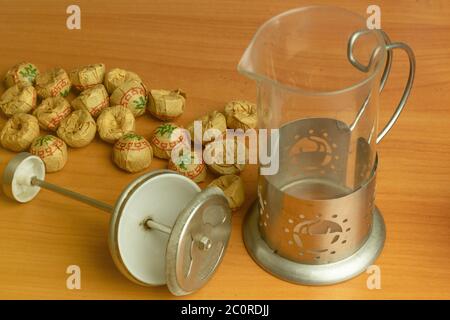 Tea time concept. Teapot with herbal tea packs top view. Stock Photo