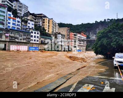 Chongqing. 12th June, 2020. Photo taken on June 12, 2020 shows flood water running past Wuxi County, southwest China's Chongqing. Vehement rainstorms have claimed one life while four others are missing in southwest China's Chongqing Municipality, local authorities confirmed Friday. Credit: Jiang Yan/Xinhua/Alamy Live News Stock Photo