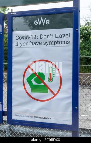 Notice at a railway station warning Covid-19: Don't travel if you have symptoms, during the coronavirus pandemic, 2020, UK Stock Photo