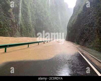 Chongqing. 12th June, 2020. Photo taken on June 12, 2020 shows a road inundated by flood water at Tianba Town in Wuxi County, southwest China's Chongqing. Vehement rainstorms have claimed one life while four others are missing in southwest China's Chongqing Municipality, local authorities confirmed Friday. Credit: Wen Shiyi/Xinhua/Alamy Live News Stock Photo