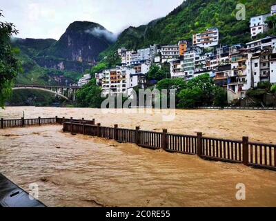 Chongqing. 12th June, 2020. Photo taken on June 12, 2020 shows a pavement submerged by flood water in Wuxi County, southwest China's Chongqing. Vehement rainstorms have claimed one life while four others are missing in southwest China's Chongqing Municipality, local authorities confirmed Friday. Credit: Jiang Yan/Xinhua/Alamy Live News Stock Photo