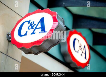Hanover, Germany. 12th June, 2020. A logo hangs on the branch of the fashion company C&A in the city centre. According to research by the business magazine 'Business Insider', customs and the Federal Employment Agency searched several offices of the fashion company C&A this week. Credit: Hauke-Christian Dittrich/dpa/Alamy Live News Stock Photo