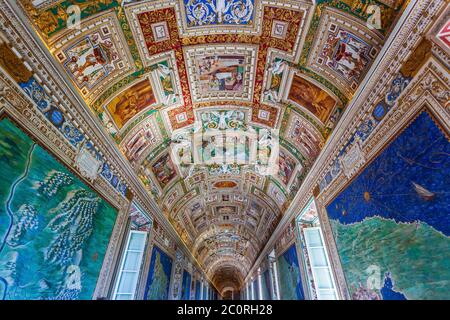 Rome, Italy - November 3, 2019: Paintings on the walls and the ceiling in the Gallery of Maps, at the Vatican Museum. Stock Photo