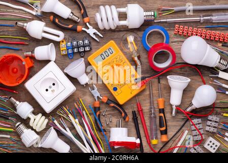 Electrician equipment on wooden background, top view Stock Photo