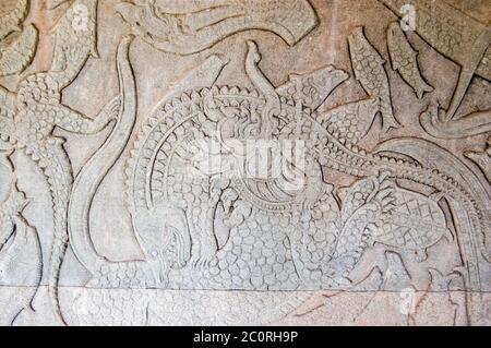 Ancient Kymer carving of the creation of the world with god fighting demons A Chinese Lion is fighting a crocodile. Churning of the Ocean of Milk gall Stock Photo