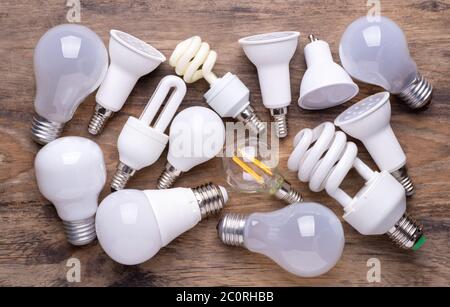 Different kinds of light bulbs on wooden background Stock Photo