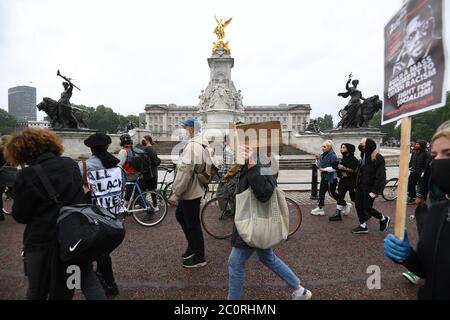 People walk past Buckingham Palace during a Black Lives Matter protest march in London.