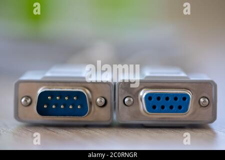 Close-up of a RS-232 serial port. Male to female extension cord on a wooden table. Stock Photo