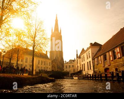 High tower of Church of Our Lady. View from canal, Bruges, Belgium Stock Photo