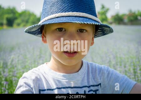 Portrait of a child with a blue hat. Lavender field in background Stock Photo