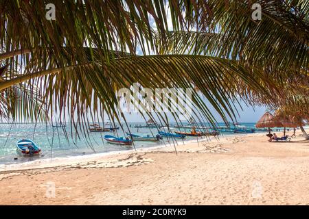Panga fleet at waters' edge on town beach, Puerto Morelos, Quintana Roo, Yucatan Stock Photo