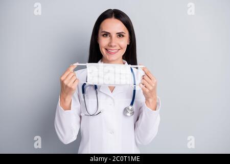 Close-up portrait of her she nice attractive lovely confident professional cheerful girl doc holding in hands cotton mask use safe life isolated over Stock Photo