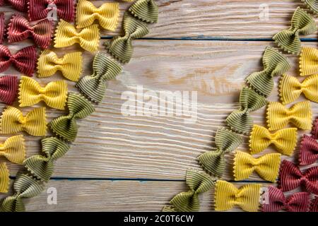 A frame of butterfly pasta on a wooden background Stock Photo