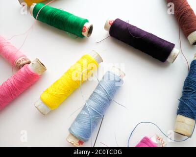 Colourful yarn on spool tube thread isolated image on white background. Stock Photo