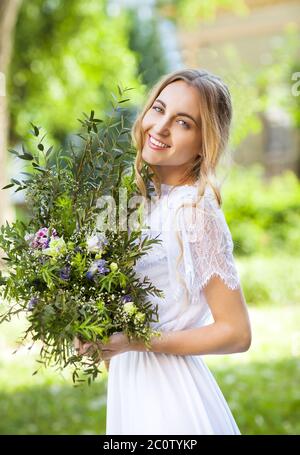 Bride with beautiful wedding bouquet of flowers in the style of boho Stock Photo