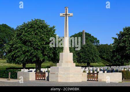 The main entrance to the Essex Farm Cemetery (1915-1918) with the Cross of Sacrifice & 49th (West Riding) Infantry Division memorial in Ypres, Belgium Stock Photo