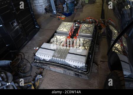 Automotive rechargeable accumulator battery from an electric car. Dismantled battery of automobile Nissan Leaf. Service station of electric cars. May Stock Photo