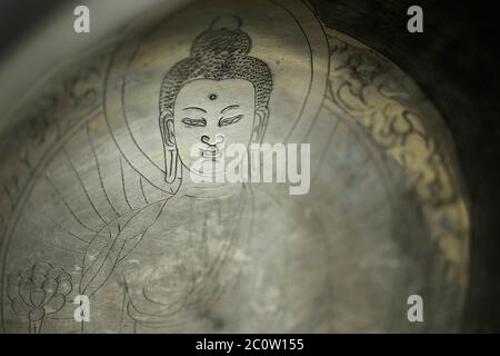 Lovely background image depicting an ancient engraving of the Buddha (very shallow depth of field)  N Stock Photo