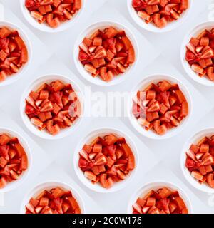 ceramic bowls with juicy strawberries on the table. red delicious berries. flat lay, seamless pattern Stock Photo