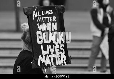 A sign / placard that reads 'All Lives Matter When Black Lives Matter' being held by a protester at a British BLM protest in 2000 Stock Photo
