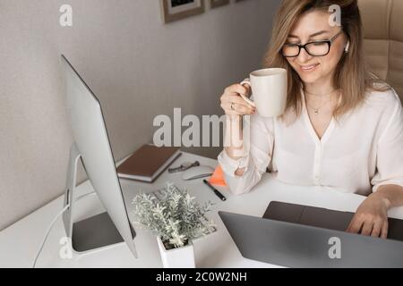 Beautiful business lady working on computers at home Stock Photo