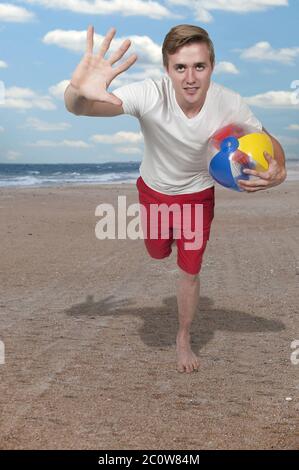 Man Holding Beach Ball Stock Photo