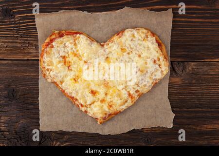 Pizza in heart shape top view. Stock Photo