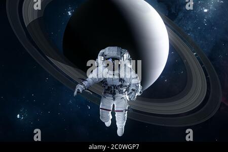 Astronaut on background of Saturn. Solar system Stock Photo