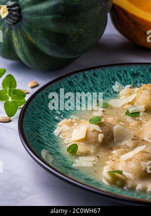 Acorn squash ravioli in broth. Stock Photo
