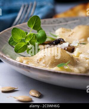 Acorn squash ravioli in broth. Stock Photo