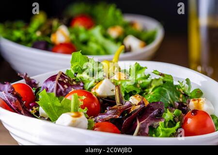 Chopped salad in white serving bowl. Stock Photo