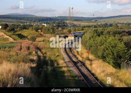 66172 'Paul Melleney' at Onllwyn with an MGR working for Aberthaw Power Station. The trackbed of the N & B's line onto Brecon is visible in a shallow Stock Photo