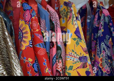 Traditional colorful red, pink, blue and yellow Kimonos from Okinawa Stock Photo