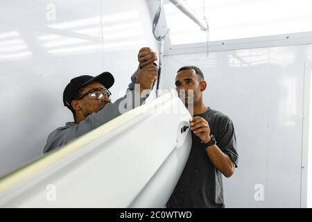 Multi races mechanics working together Stock Photo