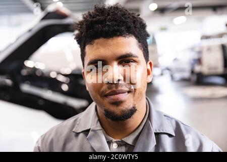 Portrait of a happy mixed race mechanic man Stock Photo