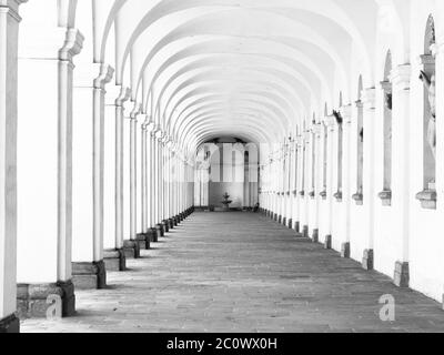 Long archway corridor with wide rib vaults. Colonnade in Kromeriz flower garden, Czech Republic. Black and white image. Stock Photo