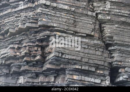 Slate Cliff face very jagged and layers sedimentary rock. High quality photo Stock Photo