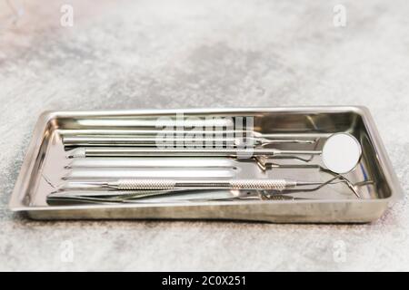 Close-up of a special metal medical set of tools in a dental office. Concepts of the dentist clinic or hospital, teeth and health care. Shallow depth Stock Photo