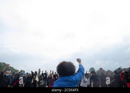 London, England, UK. 12th June, 2020.  BLM march organiser, Protestor hold a fist in the air to show solidarity . Hundreds of people joined the protes Stock Photo