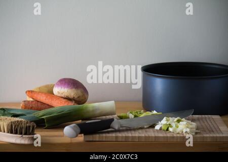 Still life with ingredients and utensils to prepare soup on a wooden table Stock Photo