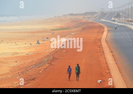 Almost empty coastal road and equally empty beach in the Guediawaye neighbourhood, Dakar, Senegal Stock Photo